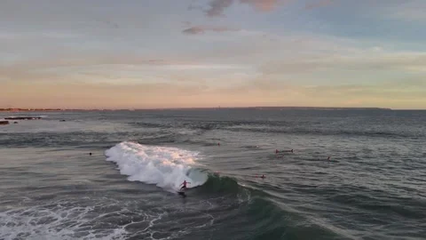 Aerial view of surfer on the wave on Canggu beach at sunset. Bali, Indonesia Stock Footage 320377040