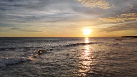 Aerial view of surfer on the wave on Canggu beach at sunset. Bali, Indonesia Stock Footage 320377046
