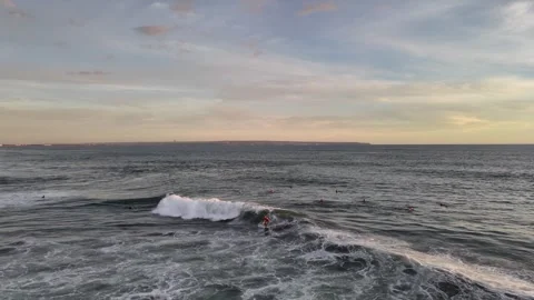 Aerial view of surfer on the wave on Canggu beach at sunset. Bali, Indonesia Stock Footage 320377074