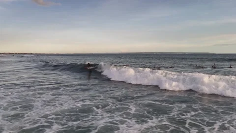 Aerial view of surfer on the wave on Canggu beach at sunset. Bali, Indonesia Stock Footage 320378462