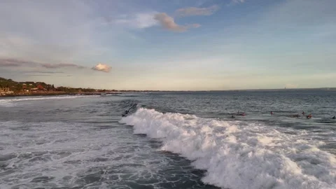 Aerial view of surfer on the wave on Canggu beach at sunset. Bali, Indonesia Stock Footage 320378468