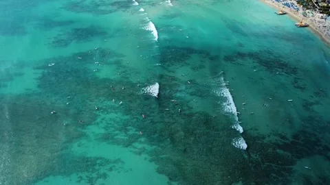 Aerial view of surfers catching waves at waikiki beach in hawaii Stock Footage 337639386