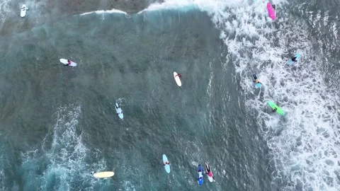 Aerial view of surfers riding waves in the ocean. Multiple unrecognizable people 스톡 동영상 341123737