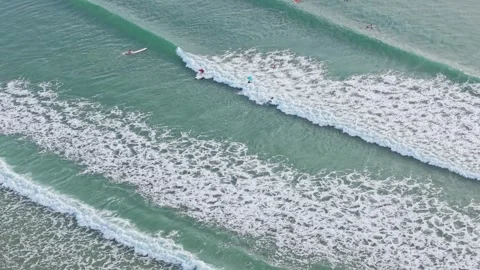 Aerial view of surfers waiting for waves in turquoise ocean at Noosa Stock Footage 335448155