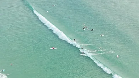 Aerial view of surfers waiting for waves in turquoise ocean at Noosa Stock Footage 335448331