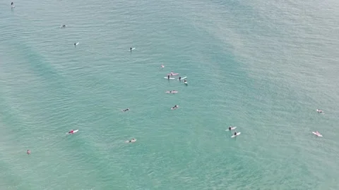 Aerial view of surfers waiting for waves in turquoise ocean at Noosa Stock Footage 335448360
