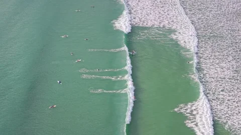 Aerial view of surfers waiting for waves in turquoise ocean at Noosa 스톡 동영상 335449560