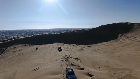 Aerial view of suv moving through the snow-covered desert in winter. Western Stock Footage 93686928