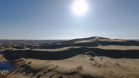 Aerial view of suvs moving through the snow-covered desert in winter. Western Stock Footage 93687085