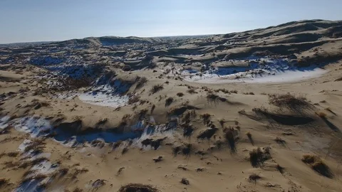 Aerial view of suvs moving through the snow-covered desert in winter. Western Stock Footage 93687307