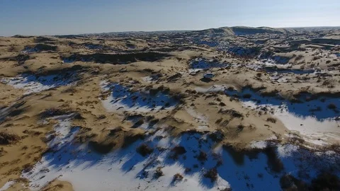 Aerial view of suvs moving through the snow-covered desert in winter. Western Stock Footage 93687458