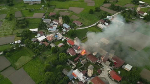 Aerial view of Svan tower on fire in Mestia, Svaneti mountains valley, Georgia Stock Footage 280292968