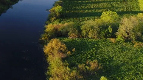 Aerial view of swamp river surrounded by green pastures with stunning landscape Stockbeeldmateriaal 117594355