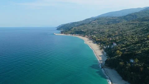 Aerial view of the sweeping coastline of Chorefto Beach on the eastern side of Stock Footage 346686979