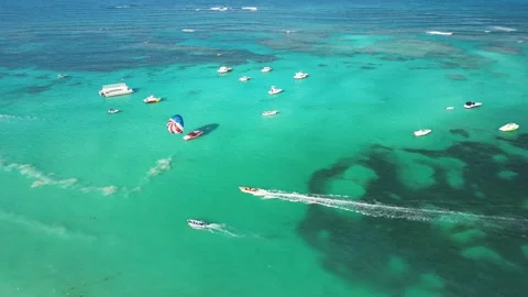 Aerial view swift boat navigating Caribbean Sea, showcasing vibrant coral reef Stock Footage 271009115