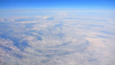 Aerial view of swirling clouds creating a vortex pattern in the sky in slow.. Stock Footage 290094338