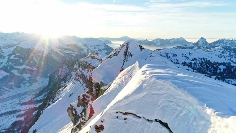 Aerial view, Swiss Alps snow mountains at sunrise, drone flying over mountaintop Stock Footage