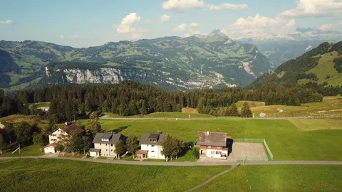 Aerial view of Swiss Mountains Cottages and Meadows in Summer Stock Footage