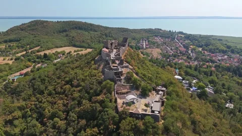 Aerial view of Szigliget castle ruins above Lake Balaton in summer forest Stock Footage 345976366