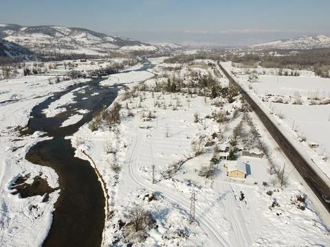 Aerial view taken by drone of river and bridge in snow Stock Photos