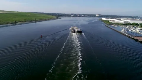 Aerial view of tanker being pushed by tugboat on the Arthur Kill Stock Footage