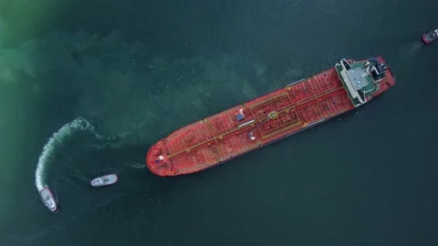 Aerial view of tanker ship with escorting tug leaving port Stock Footage 201256730