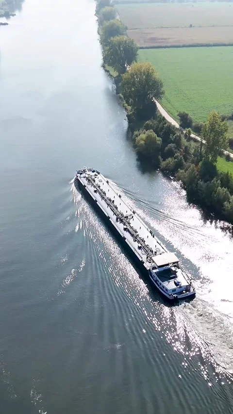 Aerial view of a tanker ship navigating a river Видео 327108629