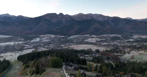 Aerial view of Tatra Mountains over frosty Zakopane at dawn Stock Footage 346613008