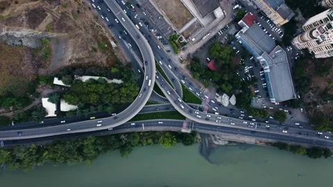 Aerial view of Tbilisi highway interchange traffic flow curving overpasses Stock Footage 343951920