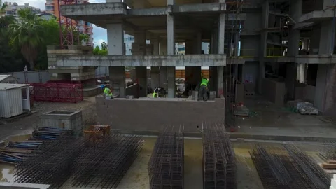 Aerial View: A team of workers readies the floor for concrete pouring while Video stock 296044028