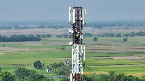 Aerial view of a technician working on a telecommunications tower. Stock Footage 335336448