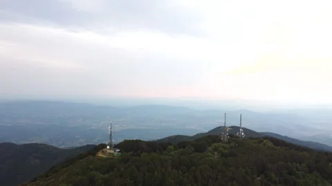 Aerial view of telecom towers on cloudy mountain ridge Stock Footage 322802728