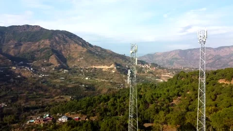 An aerial view of telecommunications tower orbits around Stock Footage 149875193