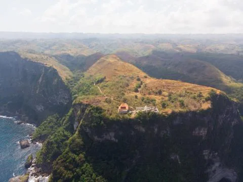 Aerial view of a temple next to a cliff Stock Photos