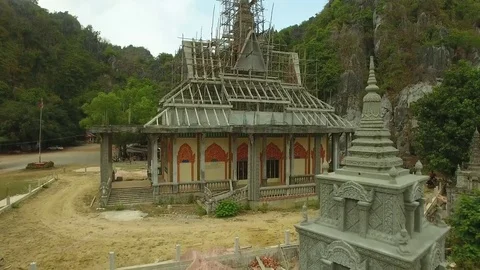 Aerial view of temple surrounded by scaffolding as restoration work - Cambodia Stock Footage 83535156
