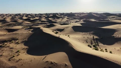 Aerial view of Tengger Desert dunes with hiker and vehicles Stock Footage 345370235