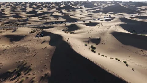 Aerial view of Tengger Desert dunes with vehicles and traveler Stock Footage 345370406