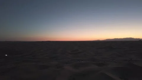 Aerial view of Tengger Desert at dusk with vehicles Видео 345369760