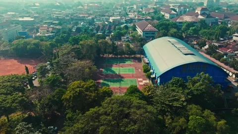 Aerial view of tennis complex and indoor sports hall in Yogyakarta Stock-Footage 342587822