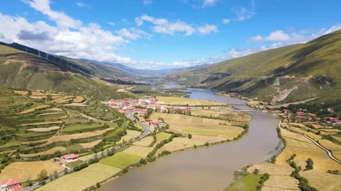Aerial view of terrace river bend village continuous green mountain valley in Video stock 337926363