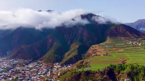 Aerial View of Terraced Fields and Village Nestled in Mountains China Vídeo Stock 347186352