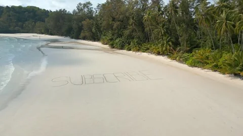 Aerial View Of The Text 'SUBSCRIBE' Written On White Sandy Tropical Beach. Stock Footage 278857555