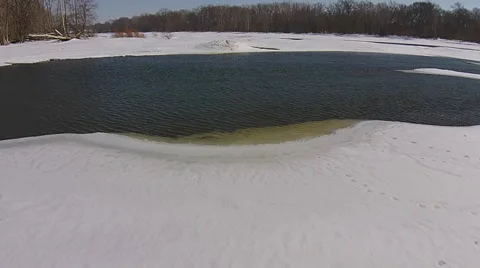 Aerial view of thawing river camera moving low over melting ice Stock Footage 49747483
