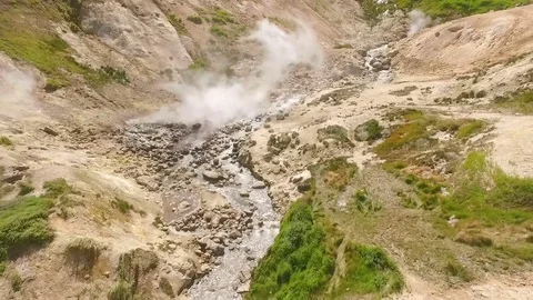 Aerial View. Thermal spring gushes out of the ground. Hot spring water in the Stock Footage 73140888