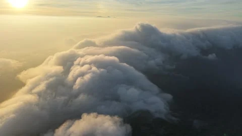 Aerial View of Thick Cloud Inversion Flowing Over Mountain Ridge at Sunrise 스톡 동영상 343698238