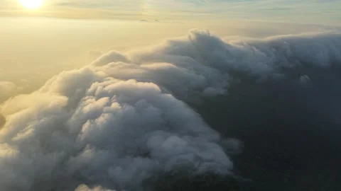 Aerial View of Thick Cloud Inversion Flowing Over Mountain Ridge at Sunrise 스톡 동영상 343698242