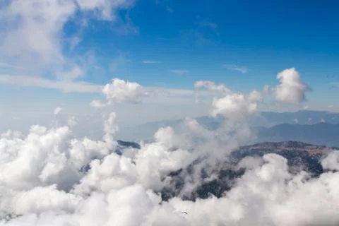 Aerial view of thick clouds formation on sunny day over the mountain Stock Photos