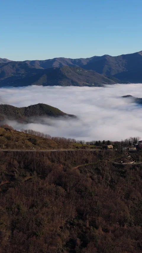 Aerial View of Thick Sea Clouds Rolling Above Italian Alpine Valleys at Sunset Stock Footage 334724275