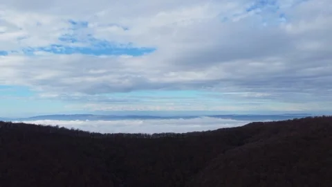 Aerial View of Thick White Clouds Over Dark Autumn Forest. A breathtaking d.. Video stock 332004602