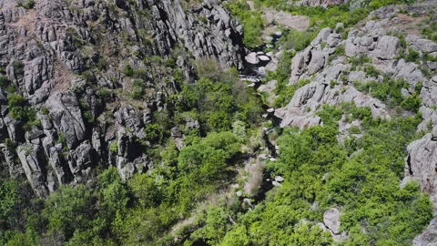 Aerial view of a thin rivulet running through a canyon in the mountains. Stock Footage 149010594
